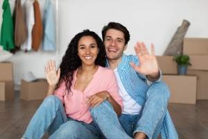 happy-couple-waving-hands-to-camera-celebrating-mo-2025-03-18-16-03-21-utc (1)