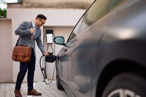 happy-businessman-charging-his-hybrid-vehicle-2024-12-13-20-57-00-utc (1)