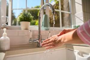 close-up-of-woman-at-home-washing-hands-in-kitchen-2024-10-19-05-22-18-utc (1)